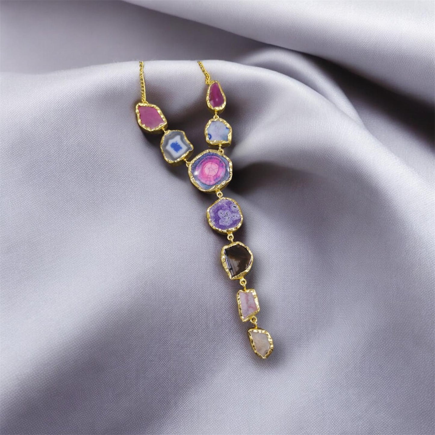 Necklace with colorful gemstones on a soft fabric background