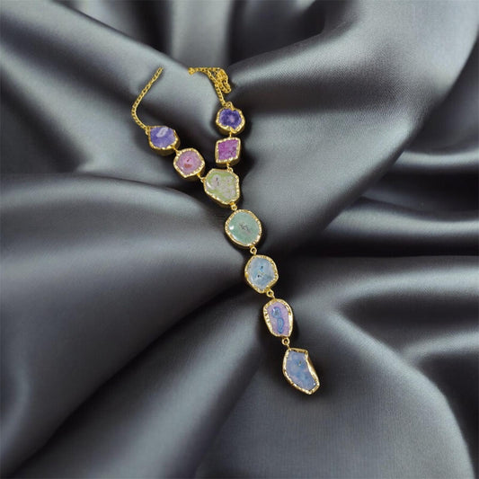 Multicolored gemstone necklace on a dark fabric background