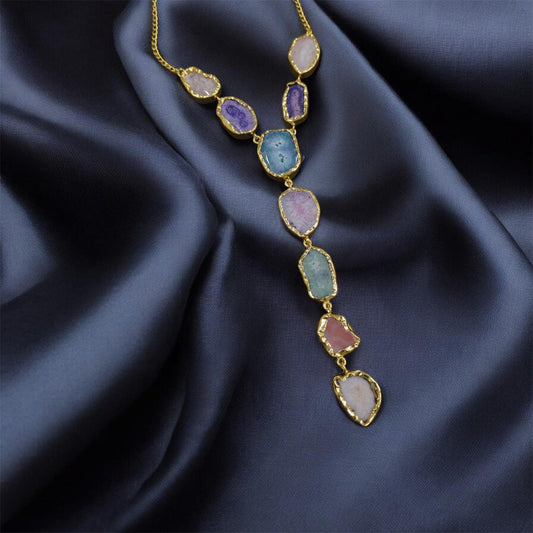 Necklace with multicolored stones on a dark blue fabric background