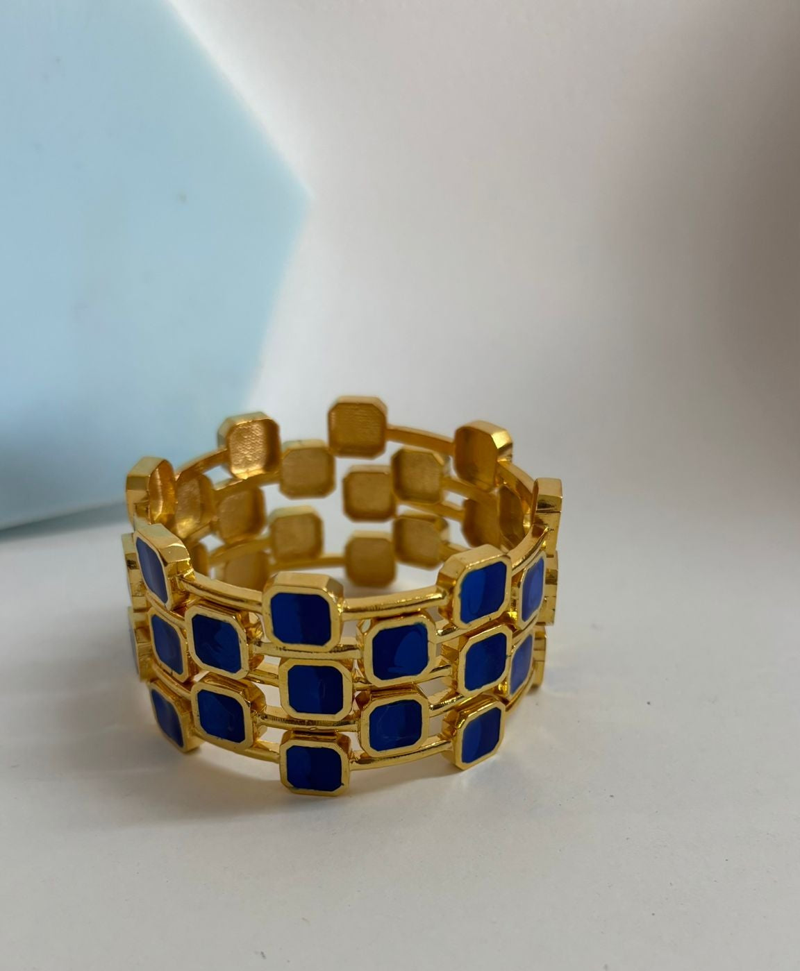 Gold and blue checkered bracelet on a white background