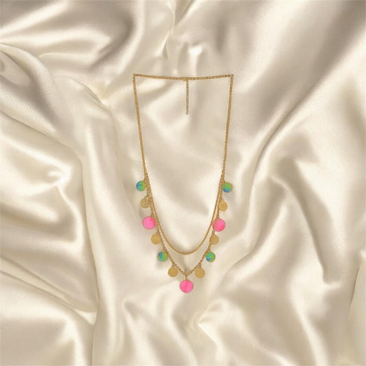 Necklace with colorful pendants on a satin surface