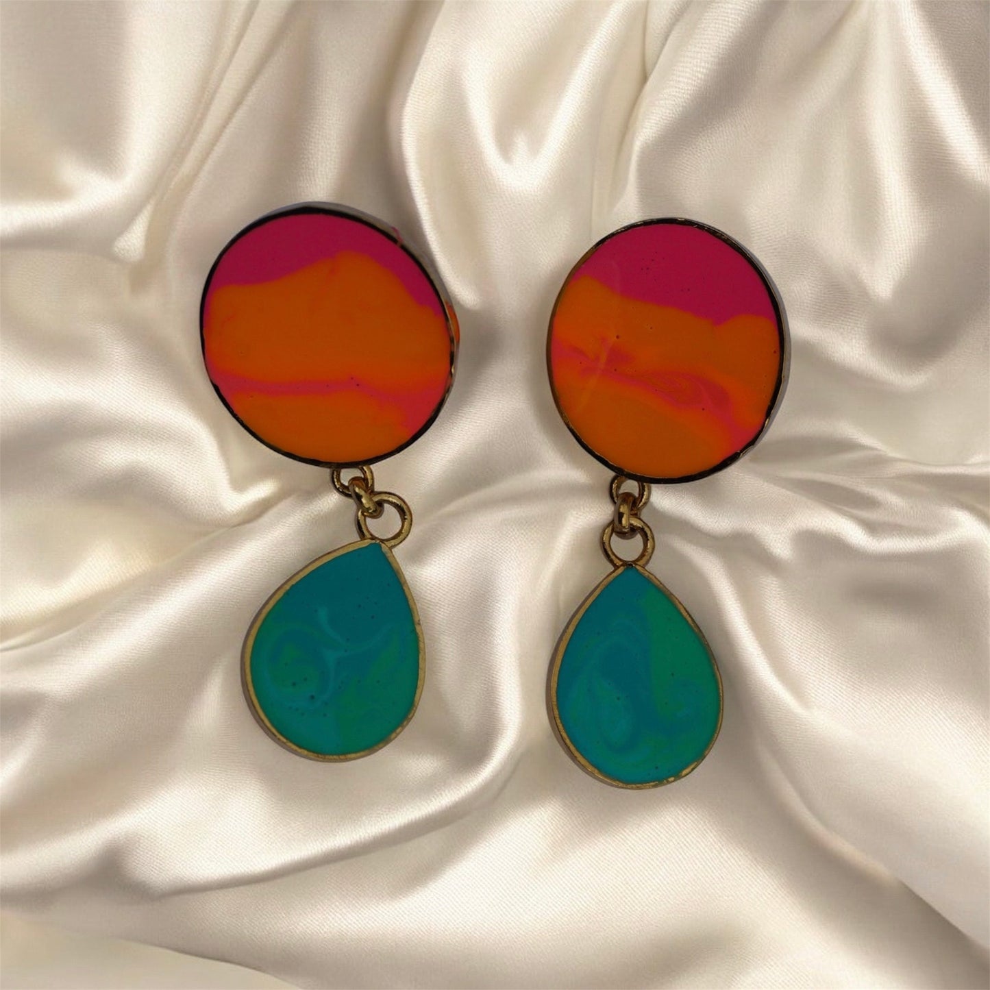 Colorful earrings on a satin surface